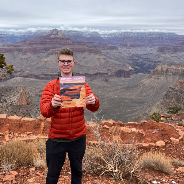 Tom holding a ParksPosters print at the Grand Canyon